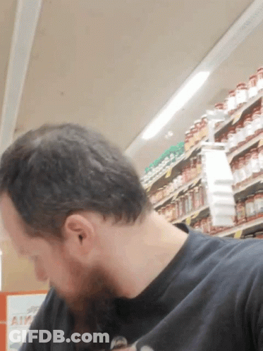 Man In Black Shirt Looking Down GIF
