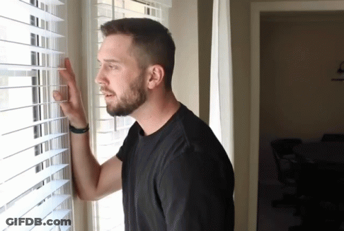 Man In Black Shirt Looking Out Window GIF