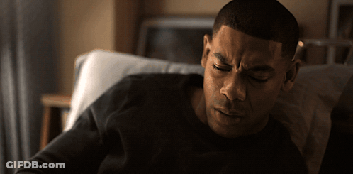 Man In Black Shirt Lying In Hospital Bed GIF