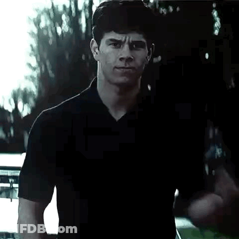 Man In Black Shirt Making Fist In Front Of Car GIF