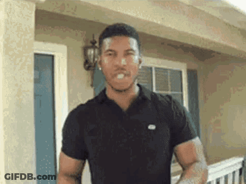 Man In Black Shirt Making Funny Face In Front Of House GIF