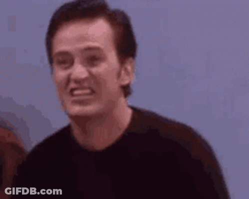 Man In Black Shirt Making Funny Face Next To Woman GIF