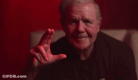 Man In Black Shirt Making Gesture On Couch GIF