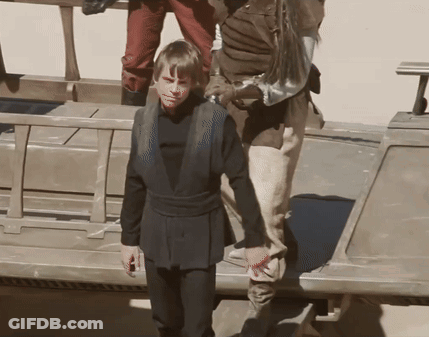 Man In Black Shirt Next To Man In Brown Shirt GIF