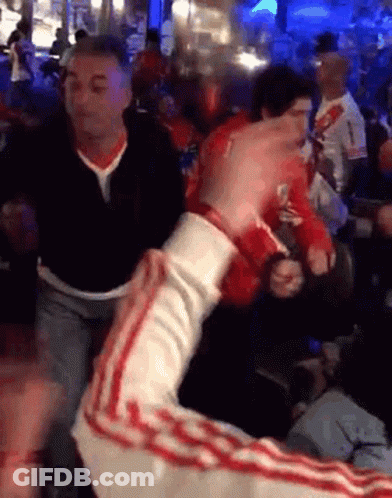 Man In Black Shirt Number 1 Holding Another Man's Arm In Crowd GIF