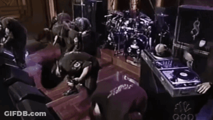 Man In Black Shirt Number 10 Kneeling At Drum Set GIF