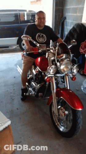 Man In Black Shirt On Red Motorcycle GIF