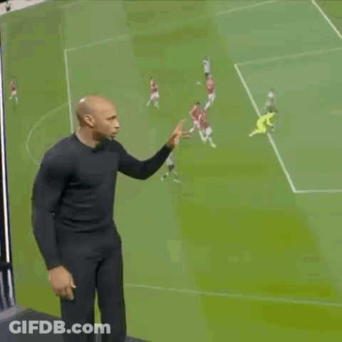 Man In Black Shirt On Soccer Field With Players GIF