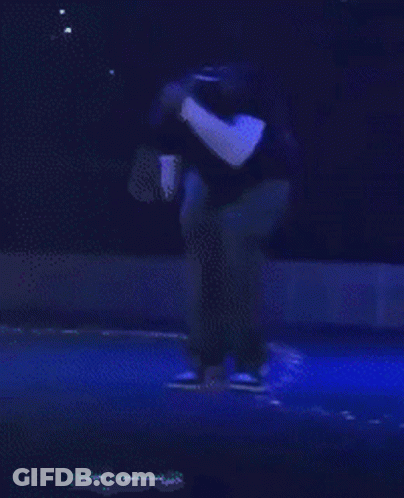 Man In Black Shirt On Stage With Blue Light GIF