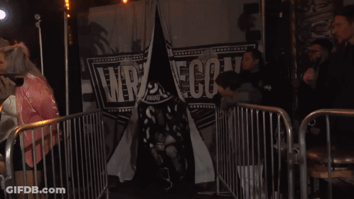 Man In Black Shirt Outstretched Hands Red Chair GIF