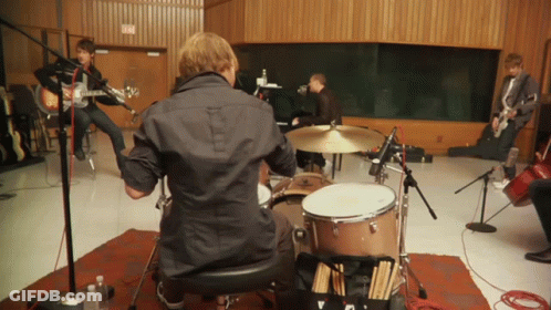 Man In Black Shirt Playing Drum Set GIF