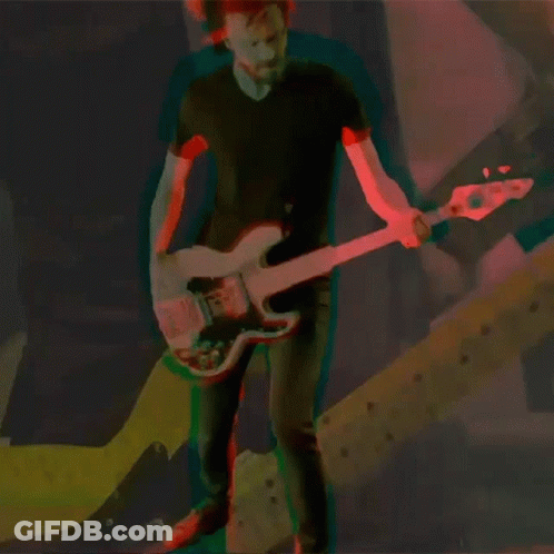 Man In Black Shirt Playing Guitar In Dark Room GIF
