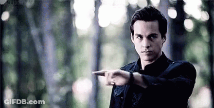 Man In Black Shirt Pointing In Forest GIF