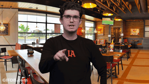 Man In Black Shirt Pointing GIF