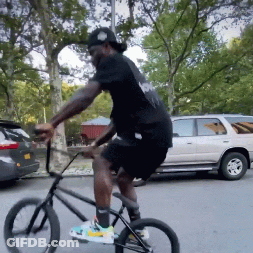 Man In Black Shirt Riding Bike GIF