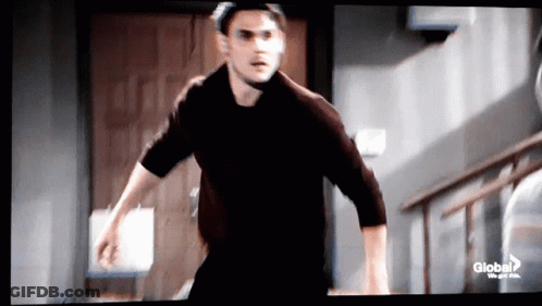Man In Black Shirt Running Down Stairs GIF