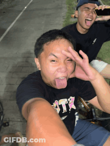 Man In Black Shirt Saying ATR Sticking Tongue Out GIF