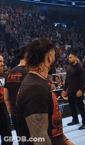 Man In Black Shirt Saying Block In Front Of Crowd GIF