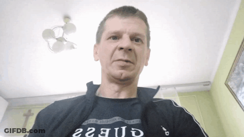 Man In Black Shirt Saying Guess GIF