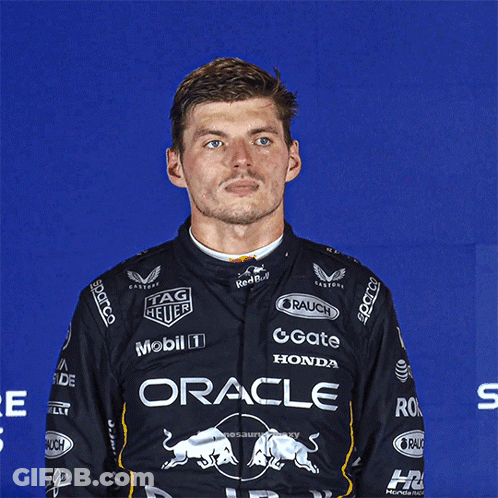 Man In Black Shirt Saying Oracle In Front Of Blue Wall GIF