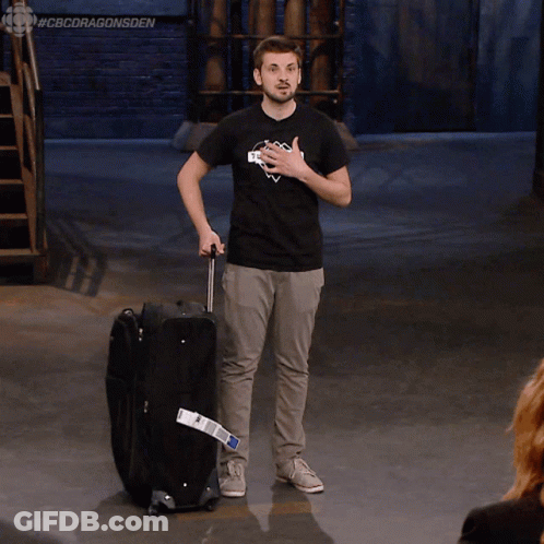 Man In Black Shirt Saying Skyscraper Pushing Suitcase GIF