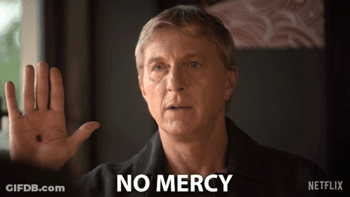 Man In Black Shirt Says No Mercy GIF