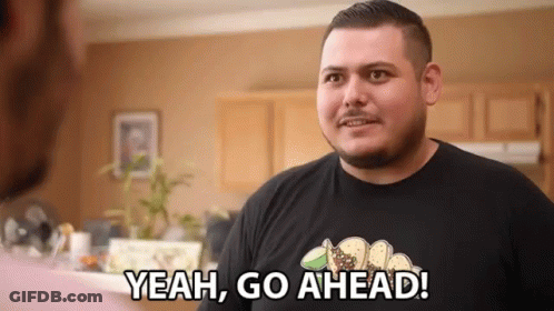 Man In Black Shirt Says Yeah Go Ahead In Kitchen GIF