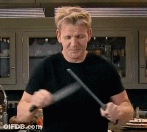 Man In Black Shirt Sharpening Knife GIF