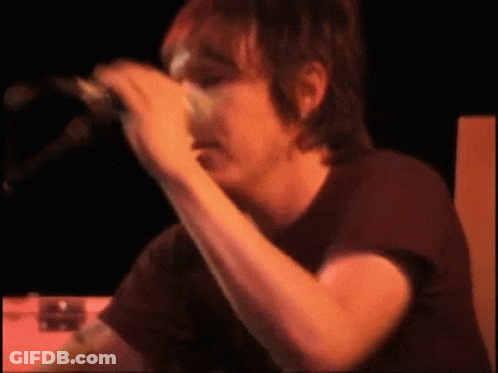 Man In Black Shirt Singing Into Microphone GIF