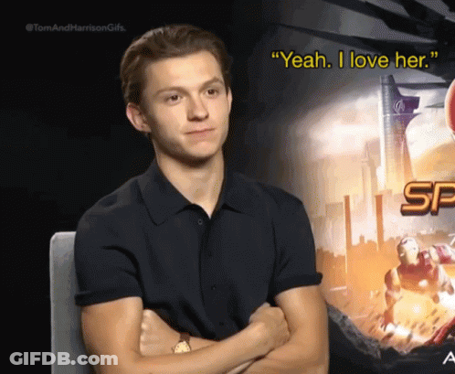 Man In Black Shirt Sitting Arms Crossed Saying Yeah I Love Her GIF