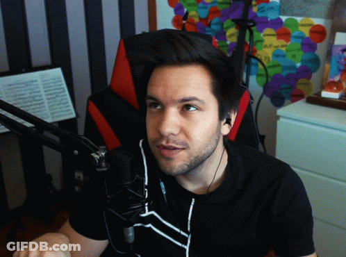 Man In Black Shirt Sitting By Microphone GIF