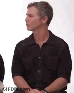 Man In Black Shirt Sitting In Chair GIF