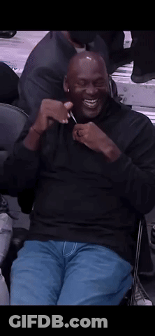Man In Black Shirt Sitting In Chair Smiling GIF