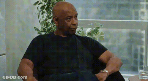 Man In Black Shirt Sitting In Chair With Glass Of Water GIF