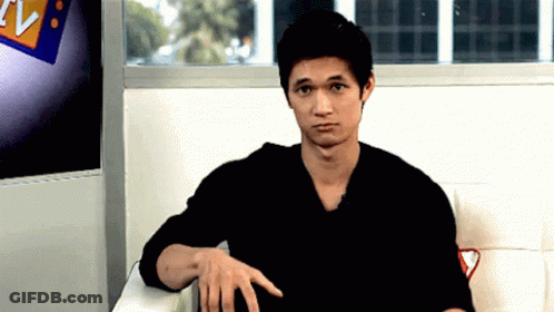 Man In Black Shirt Sitting In Front Of TV Sign GIF