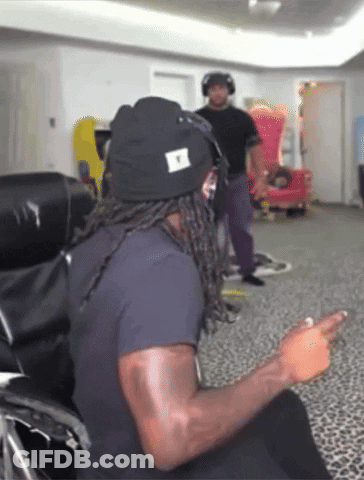 Man In Black Shirt Sitting In Red And Black Chair Justfanum GIF