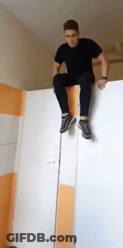 Man In Black Shirt Sitting On White Door GIF