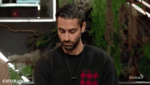 Man In Black Shirt Sitting With Eyes Closed GIF
