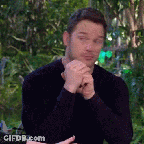 Man In Black Shirt Sitting With Folded Hands GIF
