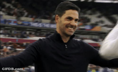 Man In Black Shirt Smiling Arms Outstretched In Front Of Crowd GIF