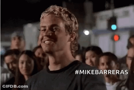 Man In Black Shirt Smiling Before Crowd GIF