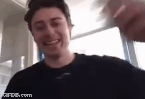 Man In Black Shirt Smiling Holding Water Glass GIF