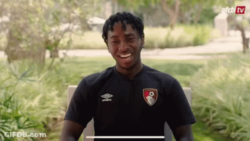 Man In Black Shirt Smiling In Park GIF