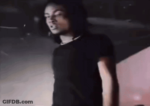 Man In Black Shirt Standing At Microphone GIF