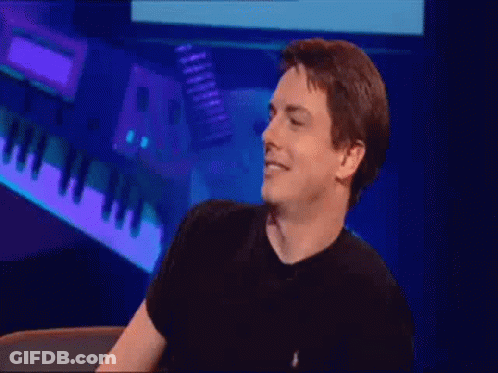 Man In Black Shirt Standing At Piano Keyboard GIF