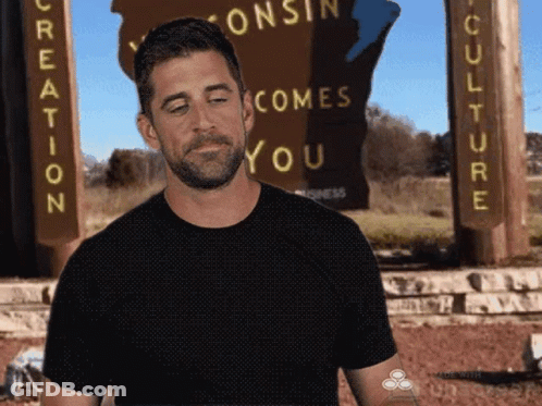 Man In Black Shirt Standing Before Creation Sign GIF