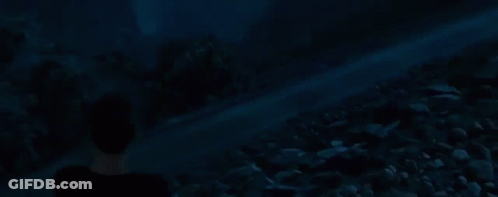 Man In Black Shirt Standing Before Crowd At Night GIF