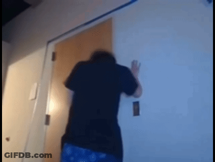 Man In Black Shirt Standing Before Door GIF