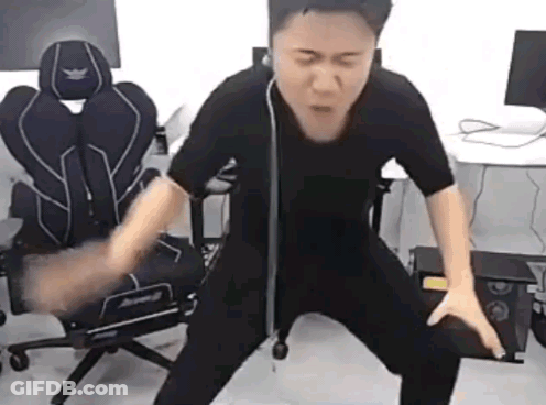 Man In Black Shirt Standing By Computer Chair GIF