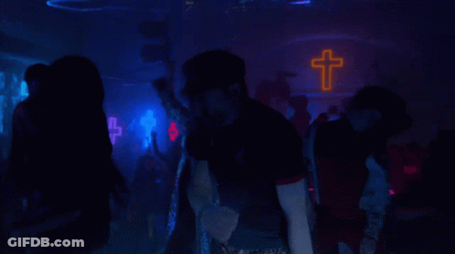 Man In Black Shirt Standing In Crowd GIF